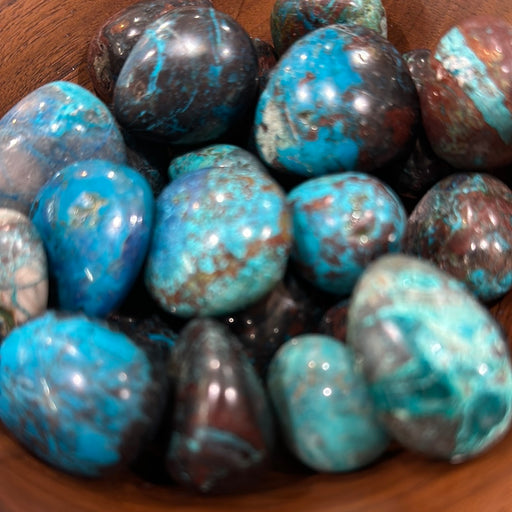 Ocho Tumbled stones from Namibia showcasing vibrant colors like blue, green, red, and brown, perfect for crystal healing enthusiasts.
