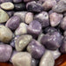 Stunning Tumbled Lepidolite Stones showcasing their calming purple and lilac hues, ideal for emotional healing and meditation.