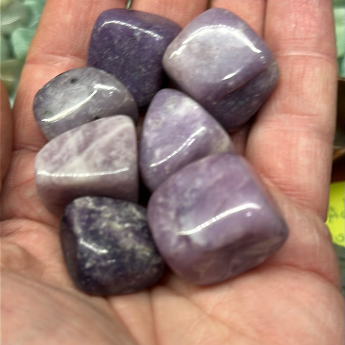 Close-up of Tumbled Lepidolite Stones, perfect for balancing stress and enhancing tranquility during meditation.