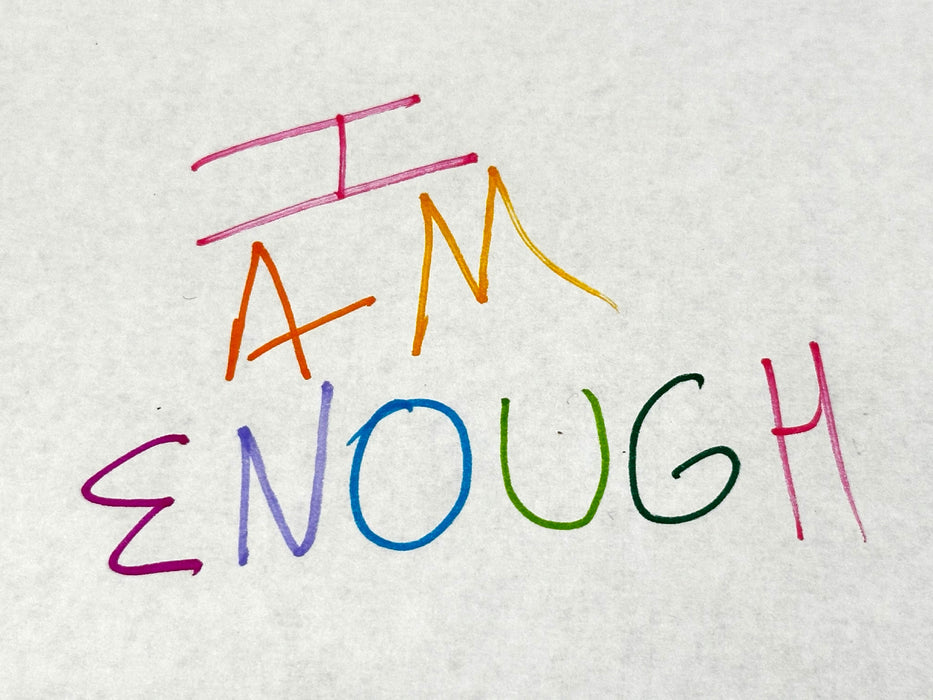 I Am Enough crystal kit containing a variety of empowering crystals including Carnelian, Malachite, and Rose Quartz.