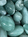 A stunning display of the I Am Enough crystal kit showcasing stones like Aventurine and Black Onyx.