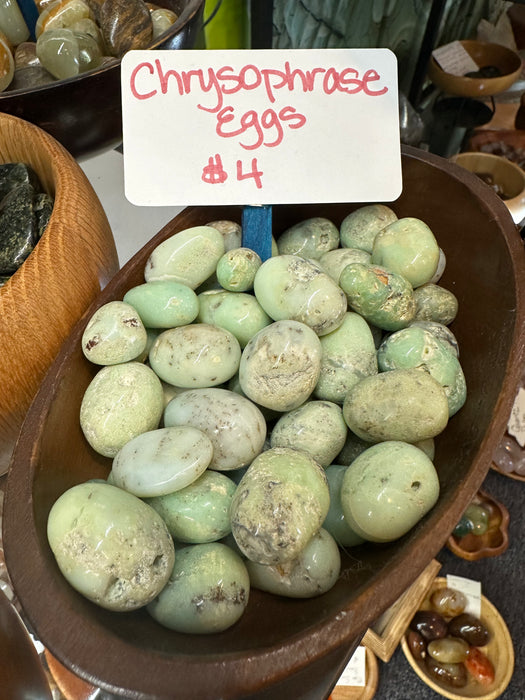 Chrysoprase tumbled eggs showcasing vibrant apple green color, known for promoting joy and happiness and detoxifying properties.