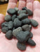Cintamani Tektite: A close-up view of the glossy black Cintamani stone, known for its powerful wish-fulfilling properties.