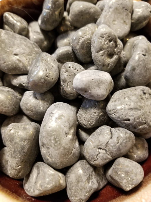 Tumbled stones featuring shimmering silver and gold hues, showcasing pyrite tumbled for crystal enthusiasts.