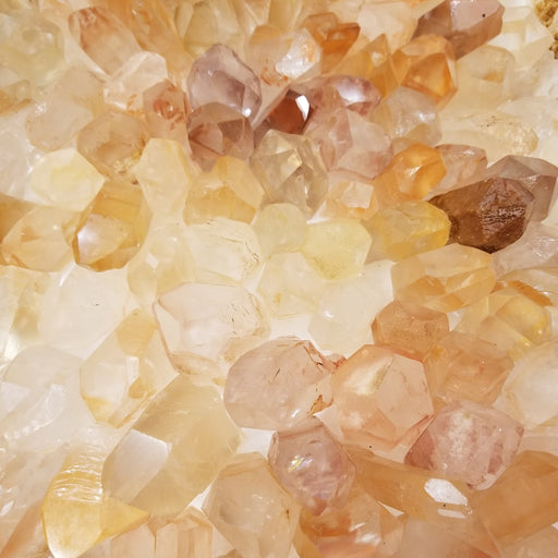 Golden Healer Quartz crystal with warm golden and orange hues, showcasing its beautiful iron oxide coating, perfect for healing energy and balancing the Crown Chakra.