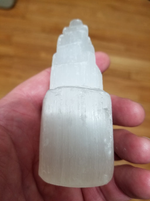 Detailed view of a Selenite Tower by High Ho Gems and Crystals, featuring a shimmering raw carved satin spar design ideal for energy clearing.