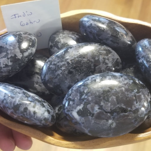 Indigo Gabro palm stone showcasing its unique healing properties, perfect for mindfulness and balance.