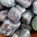 Beautiful Ruby with Kayanite tumbled stones showcasing vibrant blue and red colors, ideal for heart chakra healing and energy support.