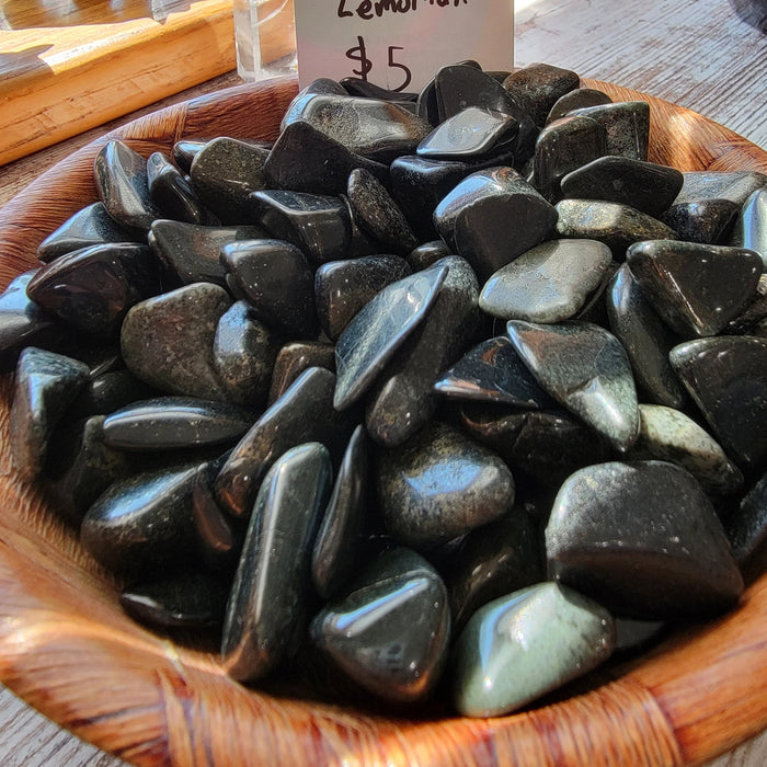 Beautiful Black Jade Lemurian tumbled stones showcasing their smooth texture and rich black color, perfect for crystal healing and decor.