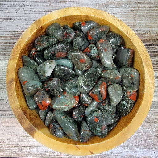 High-quality Blood Jasper tumbled stone showcasing its vibrant green and red colors, perfect for those seeking courage, vitality, and strength.