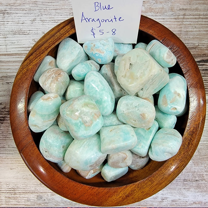 Beautiful Blue Aragonite tumbled stones showcasing vibrant turquoise water blue hues, known for their joyful vibration and ability to enhance communication and empathy.