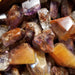 Tumbled stones - Cacoxenite Amethyst Tumbled showcasing the unique golden strands within the crystal.