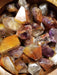 Beautifully polished Cacoxenite Amethyst Tumbled stone highlighting its rich hues of gold and brown.