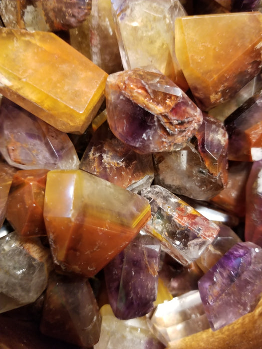 Collection of Cacoxenite Amethyst Tumbled stones, radiating light and energy with protective properties.