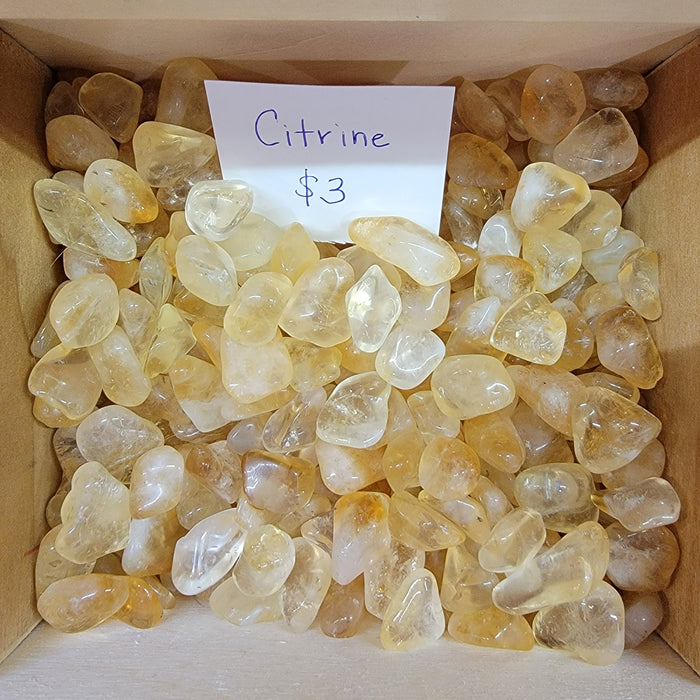 Citrine Tumbled stones, showcasing their vibrant yellow hue, ideal for energy manifestation and promoting positive vibes by High Ho Gems and Crystals.
