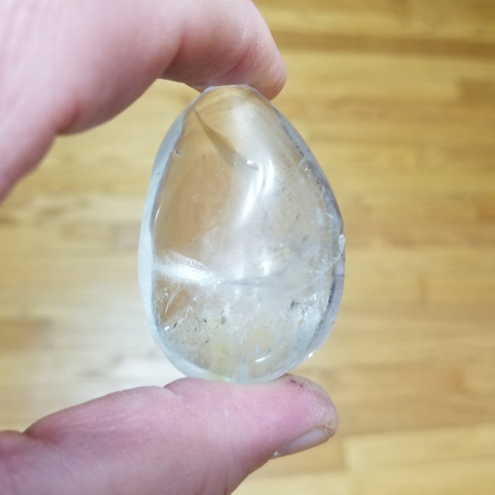 Clear Quartz palm stone, perfect for healing and meditation, offered by High Ho Gems and Crystals.