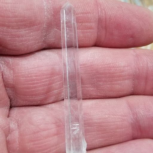 Detailed image of a Columbian Quartz Pencil emphasizing its unique natural features and vibrant clarity.