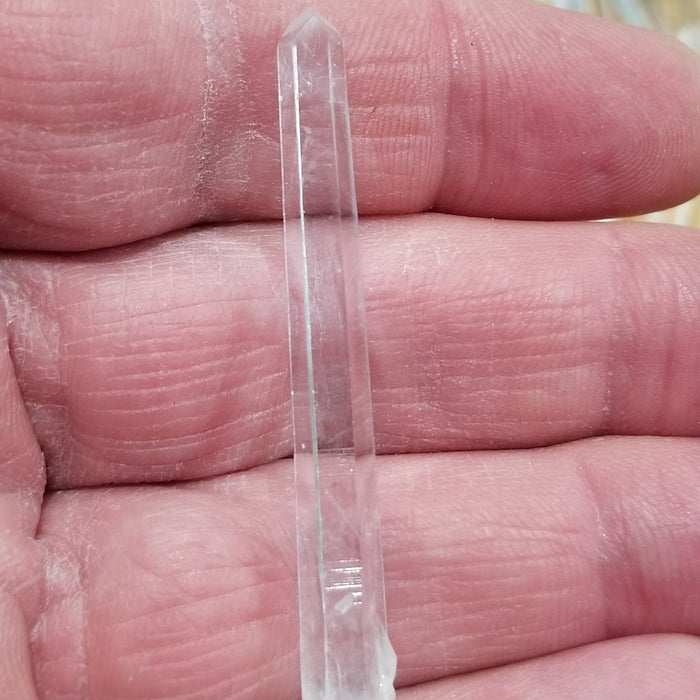 Detailed image of a Columbian Quartz Pencil emphasizing its unique natural features and vibrant clarity.