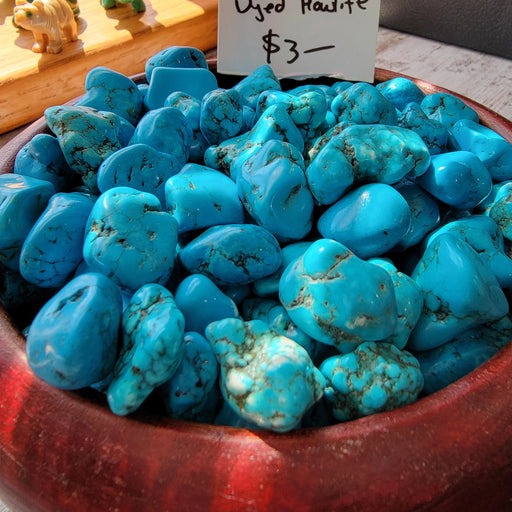 Turquenite (Dyed Howlite) Tumbled stone showcasing its vibrant blue hues and unique pattern, perfect for crystal healing and decoration.