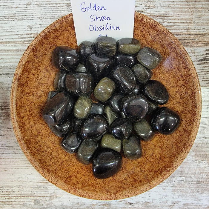 Stunning Golden Sheen Obsidian tumbled stones showcasing their beautiful black color with a shimmering golden sheen, perfect for grounding and clarity in your life.