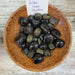 Stunning Golden Sheen Obsidian tumbled stones showcasing their beautiful black color with a shimmering golden sheen, perfect for grounding and clarity in your life.