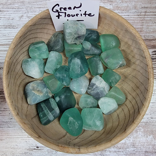 Tumbled stones - Fluorite Green from India, showcasing their vibrant green color and unique textures, known for their grounding energy and healing properties.