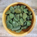 Tumbled stones of Green Chalcedony from High Ho Gems and Crystals, showcasing their vibrant green color and natural beauty.