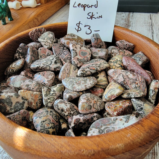 Leopard Skin Jasper tumbled stones showcasing unique patterns, perfect for meditation and decor, highlighting their healing properties.