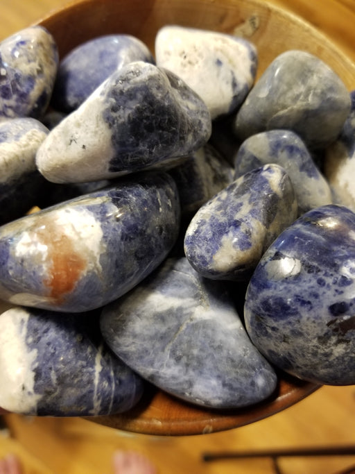 A beautiful Sodalite tumbled large stone showcasing vibrant blue and white hues, perfect for enhancing intuition and emotional balance.
