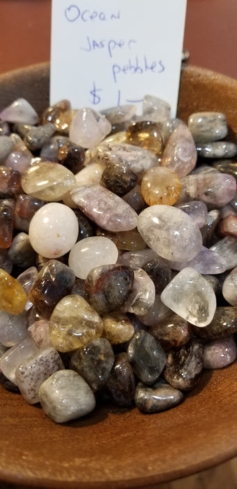 Close-up of Ocean Jasper Palm stones highlighting unique patterns and colors like green, yellow, and brown, perfect for chakra healing and meditation.