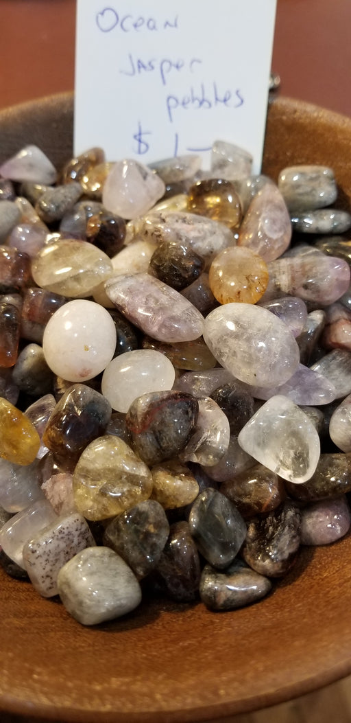 Close-up of Ocean Jasper Palm stones highlighting unique patterns and colors like green, yellow, and brown, perfect for chakra healing and meditation.