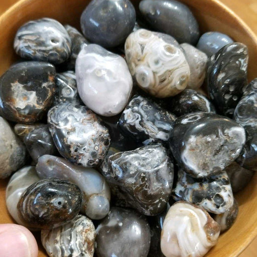 Stunning Tumbled Stones Oco Geode displaying unique patterns in shades of black, brown, grey, and white, ideal for decor and spiritual energy.
