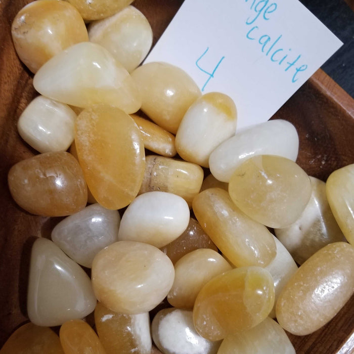 Tumbled Stones - Orange Calcite tumbled, showcasing its vibrant orange color and unique texture, perfect for enhancing creativity and promoting positive energy.
