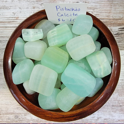 Beautiful tumbled stones of Pistacio Calcite Tumbled, featuring large to extra-large light green pieces, perfect for the heart chakra.