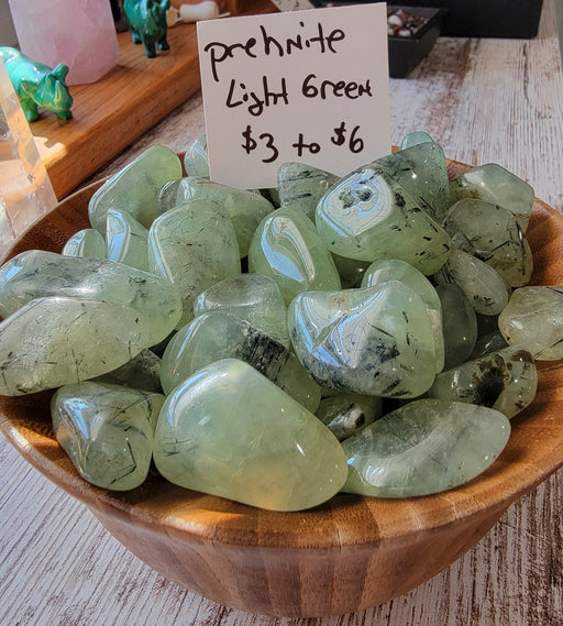 High Ho Gems and Crystals Prehnite Tumbled stones showcasing their beautiful light green color, perfect for crystal enthusiasts and collectors.