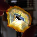 Eye-catching Rainbow Iris Agate Slice with beautiful swirling patterns, perfect for meditation or decorative purposes.
