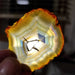Translucent Rainbow Iris Agate Slice displayed elegantly on a wooden surface, ideal for crystal collectors.