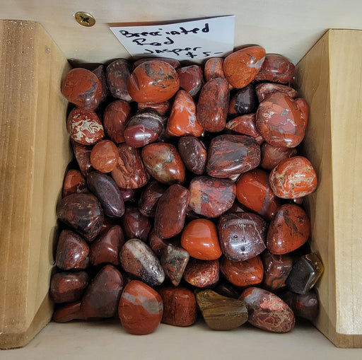 Beautiful Red Brecciated Jasper Tumbled stone showcasing rich hues of red, brown, and grey, known for enhancing strength and grounding energy.