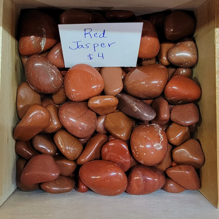 Tumbled stones - Red Jasper tumbled showcasing vibrant red and grey streaks, known for its empowering and grounding properties, ideal for enhancing physical strength and energy.
