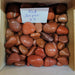 Tumbled stones - Red Jasper tumbled showcasing vibrant red and grey streaks, known for its empowering and grounding properties, ideal for enhancing physical strength and energy.