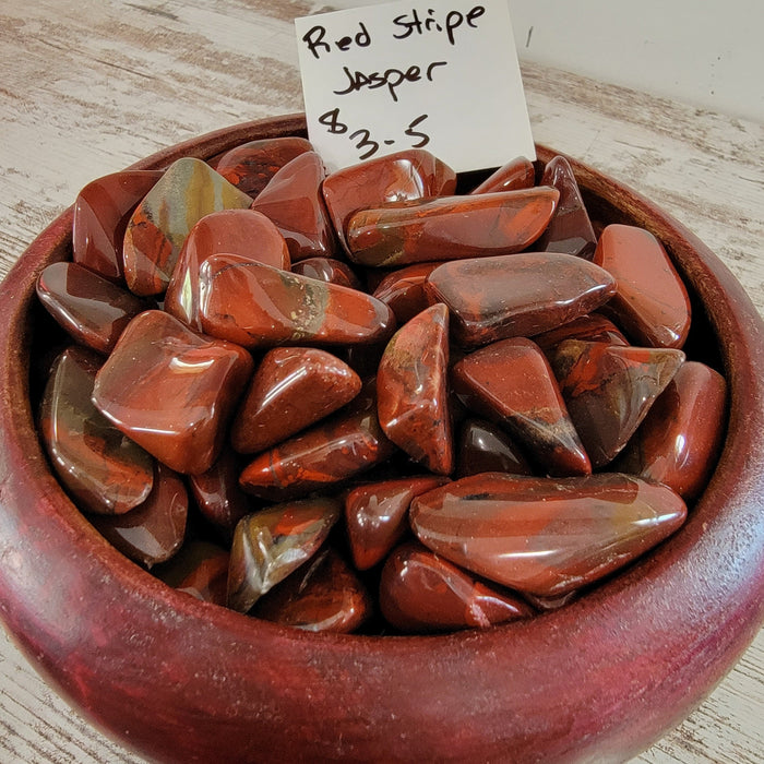 Beautiful Red Stripe Jasper tumbled stones showcasing unique red patterns, perfect for crystal healing and decoration.