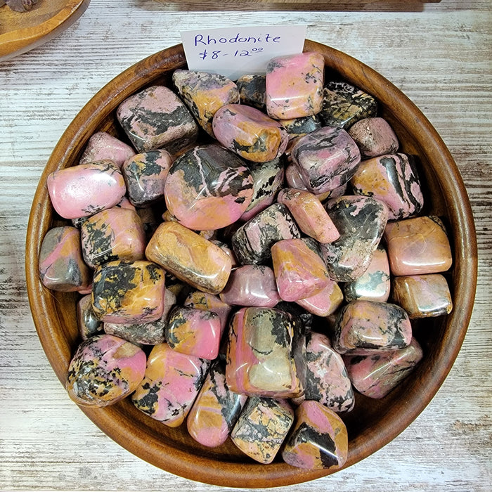 Beautiful Rhodonite AA Tumbled stones for emotional healing and balance, showcasing vibrant pink hues.