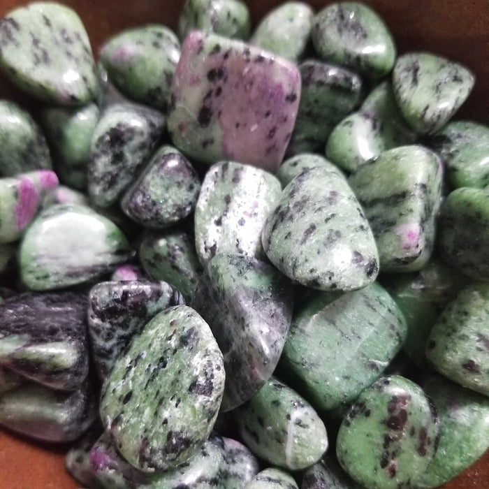 Tumbled stones - Ruby Zoisite tumbled, showcasing vibrant colors and unique patterns, perfect for enhancing happiness and spiritual healing.