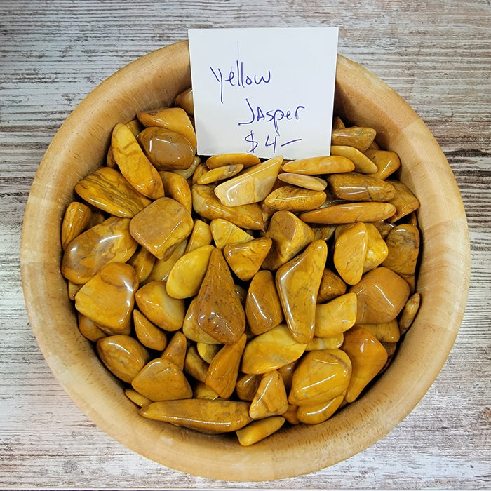 Yellow Jasper tumbled stone, showcasing its vibrant yellow color and natural patterns, perfect for crystal healing and energy work.