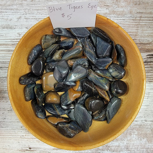 Blue Tigers Eye Tumbled stones showcasing their vibrant blue color and unique chatoyancy effects, perfect for meditation and promoting focus.