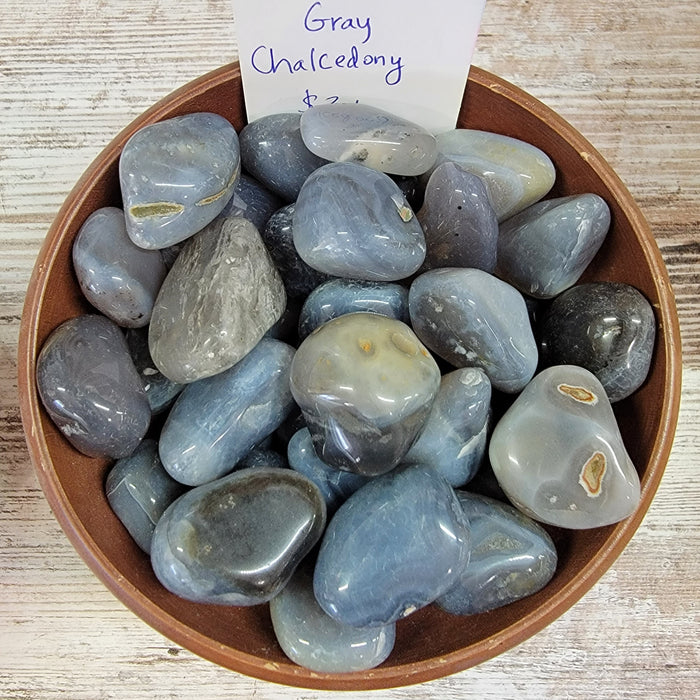 Gray Chalcedony tumbled stones from High Ho Gems and Crystals, showcasing their beautiful gray color in sizes ranging from 1/2 to 1.5 inches.