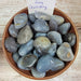 Gray Chalcedony tumbled stones from High Ho Gems and Crystals, showcasing their beautiful gray color in sizes ranging from 1/2 to 1.5 inches.