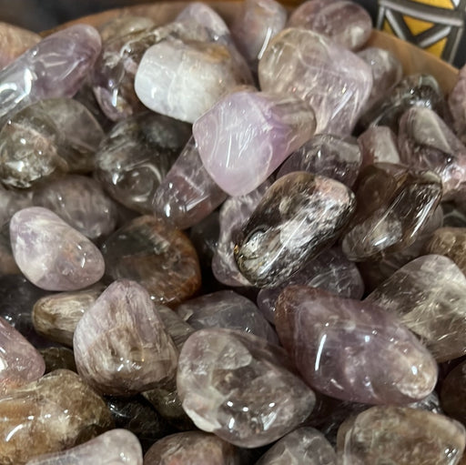 Super 7 - Melody Stone Tumbled showcasing its beautiful color variations including peach, pink, green, gray, and more.