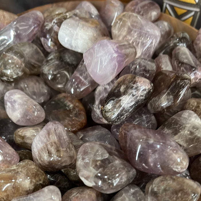 Super 7 - Melody Stone Tumbled showcasing its beautiful color variations including peach, pink, green, gray, and more.