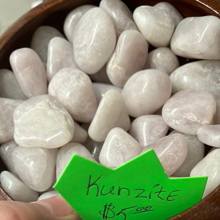Beautiful Kunzite tumbled stones showcasing their delicate pink and lavender hues, perfect for crystal healing and decoration.